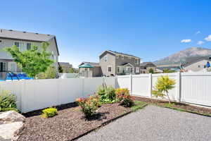 Fenced backyard featuring a residential view and a mountain view