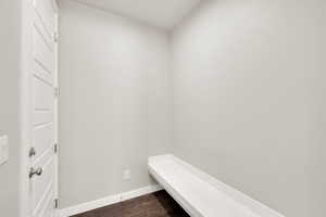 Mudroom featuring baseboards and dark wood finished floors