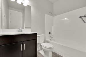 Full bath featuring vanity, wood finished floors, and  shower combination