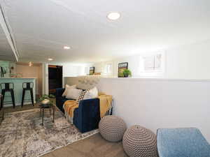 Living room featuring carpet, a textured ceiling, and recessed lighting