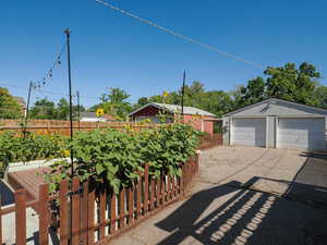 View of yard with a garage and an outdoor structure