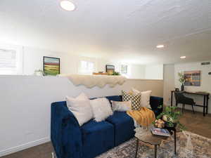 Carpeted living area with a textured ceiling and recessed lighting