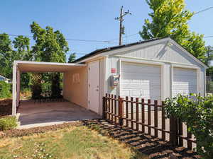 Detached garage featuring a carport