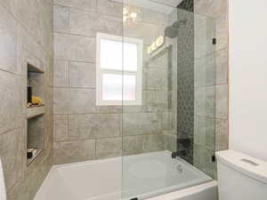 Full bathroom with washtub / shower combination and toilet