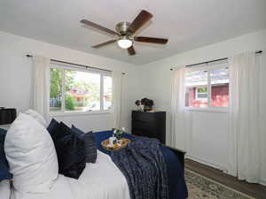 Bedroom featuring wood finished floors, a textured ceiling, and ceiling fan