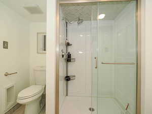 Bathroom with a stall shower and toilet