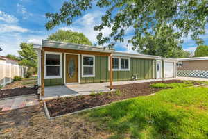 View of front of home with board and batten siding, an attached garage, and concrete driveway