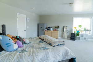 Carpeted bedroom with a textured ceiling