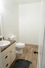Half bathroom featuring light wood-style floors and vanity