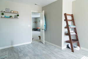 Hall with baseboards and light wood-type flooring