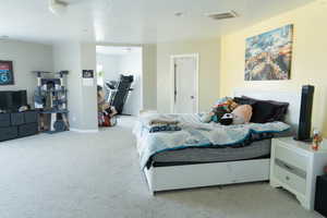 Bedroom with light colored carpet and baseboards