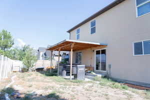 Back of house with a patio and stucco siding