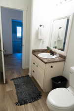 Half bath featuring wood tiled floors and vanity