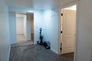 Corridor featuring dark wood-style floors and a textured ceiling