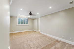 Spare room with light colored carpet, ornamental molding, ceiling fan, and recessed lighting