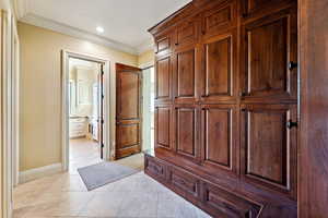 Interior space featuring crown molding, light tile patterned flooring, and recessed lighting