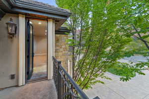 Property entrance featuring stone siding and stucco siding