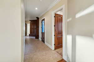 Hall featuring ornamental molding and recessed lighting