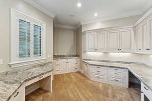 Unfurnished office featuring built in study area, ornamental molding, light carpet, and recessed lighting