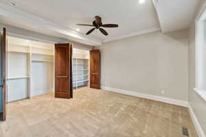 Unfurnished bedroom featuring light carpet, ornamental molding, recessed lighting, and a ceiling fan