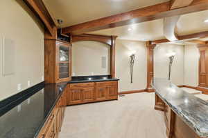 Home theater room with light carpet, beamed ceiling, recessed lighting, and decorative columns