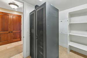 Corridor featuring light tile patterned floors and baseboards