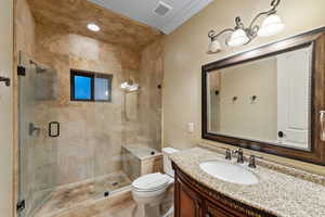 Full bath with crown molding, a stall shower, and vanity