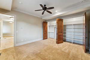Unfurnished bedroom featuring light carpet, crown molding, two closets, a ceiling fan, and recessed lighting
