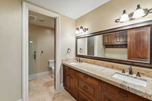 Full bath with toilet and double vanity