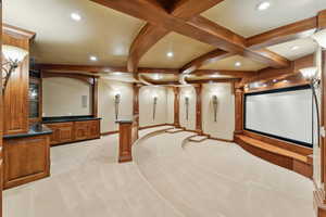 Home theater featuring light carpet, beam ceiling, recessed lighting, and ornate columns