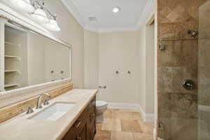 Full bathroom featuring crown molding, a shower stall, and vanity