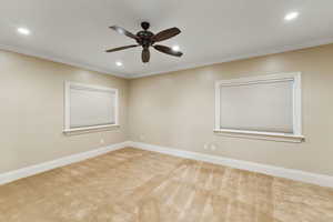 Empty room with carpet flooring, ornamental molding, ceiling fan, and recessed lighting