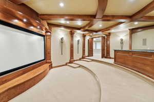 Cinema featuring decorative columns, beamed ceiling, light carpet, and recessed lighting