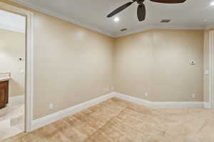 Spare room featuring a ceiling fan, ornamental molding, light carpet, and recessed lighting