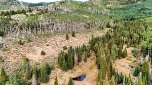 Aerial view of property and surrounding area featuring mountains
