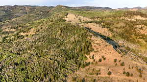 Aerial view of property and surrounding area with mountains and rural landscape