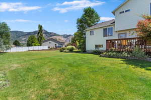 View of yard featuring a deck with mountain view