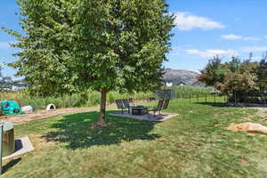 View of yard with an outdoor fire pit and a mountain view