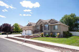 View of front of home featuring stucco siding, stone siding, concrete driveway, and an attached garage