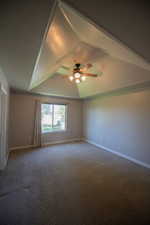 Unfurnished room featuring carpet floors and ceiling fan