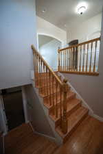 Staircase featuring wood finished floors