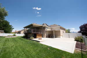 Back of property with roof mounted solar panels, a patio area, and a fenced backyard