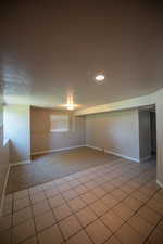 Spare room with light colored carpet and a textured ceiling