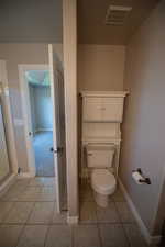 Bathroom featuring baseboards and tile patterned flooring