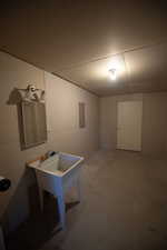 Below grade area featuring a sink and electric panel