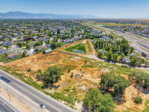 Aerial perspective of suburban area with a mountainous background and a main thoroughfare