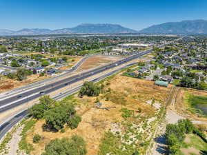 Aerial perspective of suburban area featuring mountains and a main thoroughfare