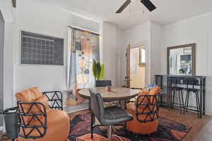 Dining space with ceiling fan and wood finished floors
