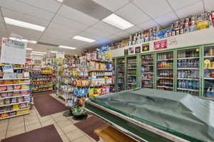 Miscellaneous room with a paneled ceiling and tile patterned floors