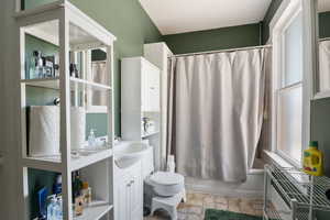 Bathroom with vanity and shower / bath combination with curtain